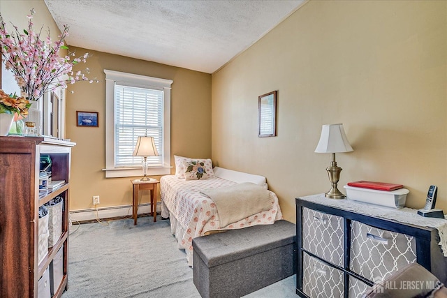 carpeted bedroom featuring a baseboard heating unit, baseboards, and a textured ceiling