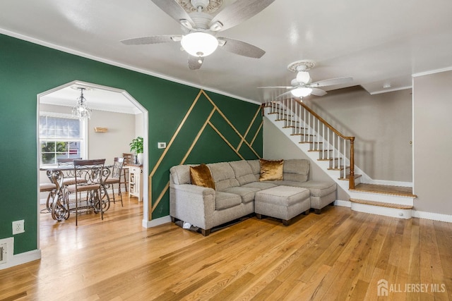 324 Greene Ave, Middlesex, NJ 08846 - living room with crown molding, stairway, ceiling fan, light wood-style flooring, and arched walkways