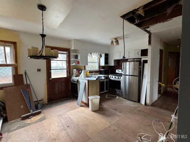 kitchen with hanging light fixtures, light countertops, a kitchen island, and stainless steel appliances