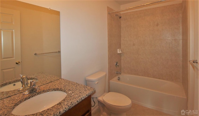 full bathroom with tile patterned floors, vanity, tiled shower / bath combo, and toilet