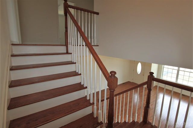 staircase with wood-type flooring