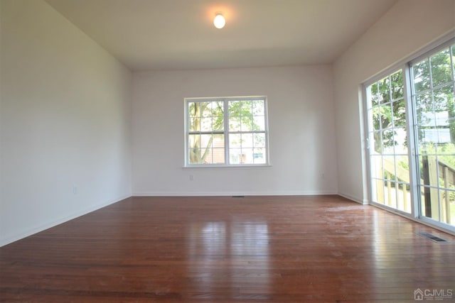 spare room with dark hardwood / wood-style floors