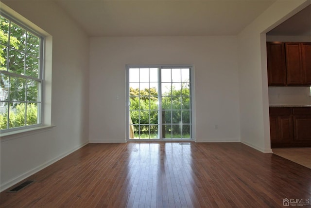 spare room with dark hardwood / wood-style floors