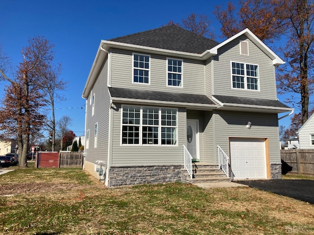 view of front of home featuring a garage and a front lawn