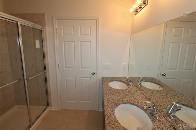 bathroom featuring tile patterned floors, vanity, and walk in shower