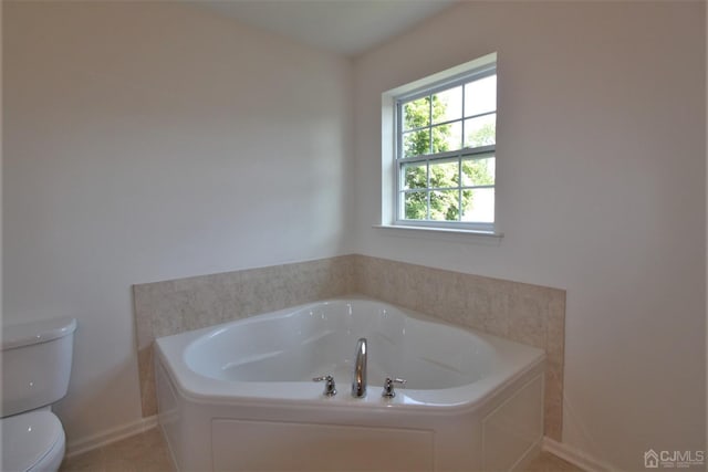 bathroom with a bathing tub and toilet