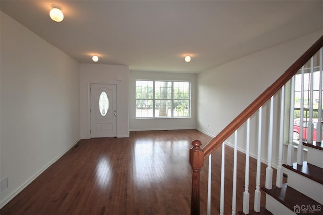 entryway with dark hardwood / wood-style flooring