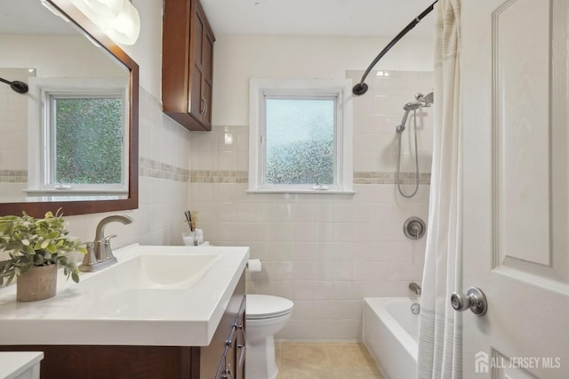 bathroom featuring toilet, tile walls, shower / bathtub combination with curtain, vanity, and tile patterned floors