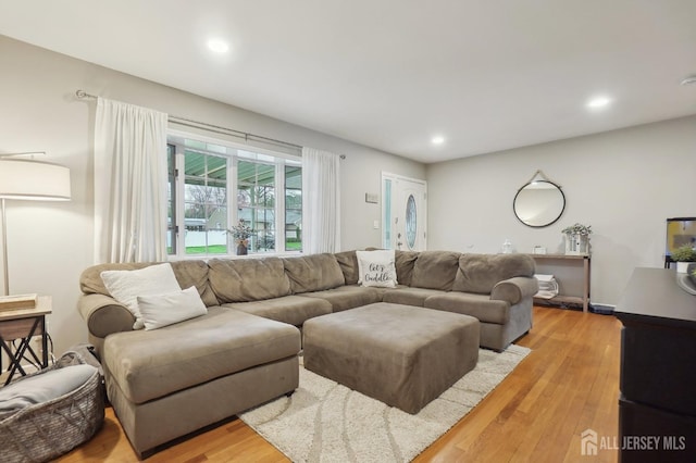 living room featuring light wood finished floors and recessed lighting