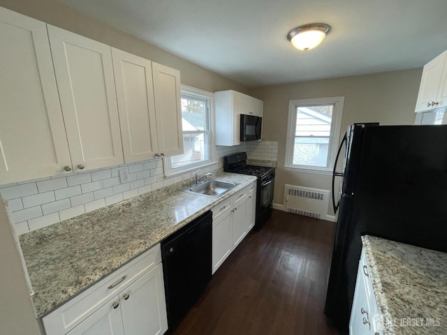 520 Hayward St, Bound Brook, NJ 08805 - kitchen featuring black appliances, a sink, radiator, dark wood-style floors, and tasteful backsplash