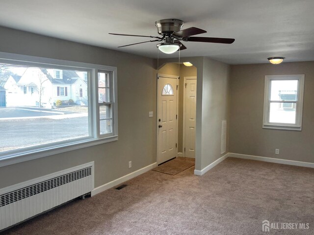 520 Hayward St, Bound Brook, NJ 08805 - carpeted foyer with radiator heating unit, a ceiling fan, and baseboards