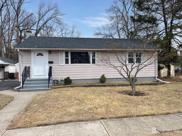 520 Hayward St, Bound Brook, NJ 08805 - view of front of house with a chimney, a shingled roof, and a front yard