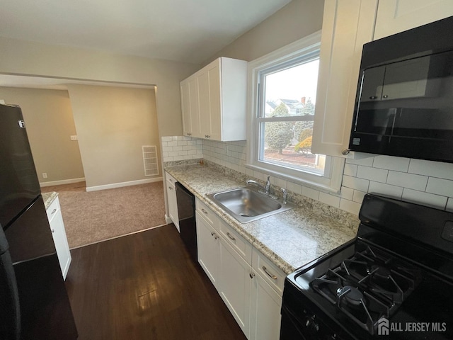 520 Hayward St, Bound Brook, NJ 08805 - kitchen featuring black appliances, a sink, dark wood-type flooring, light countertops, and white cabinets