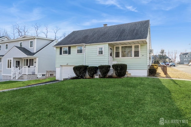 view of front of house with a garage and a front lawn