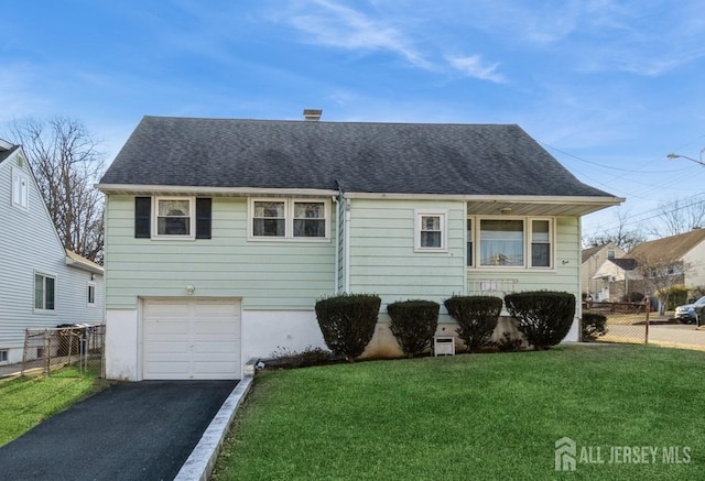 view of front facade with a garage and a front yard