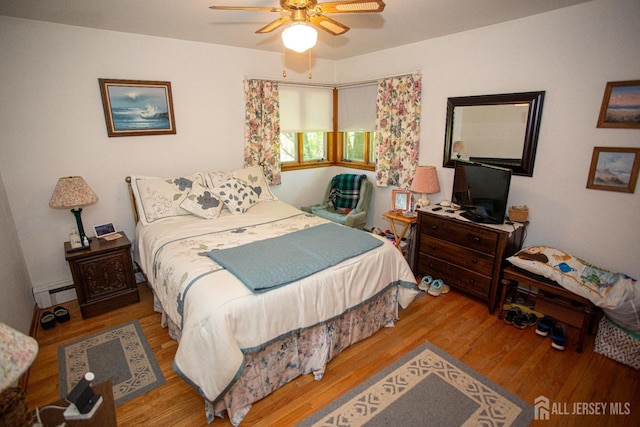 282 Bridgepoint Rd, Montgomery, NJ 08502 - bedroom featuring a baseboard heating unit, wood finished floors, and a ceiling fan