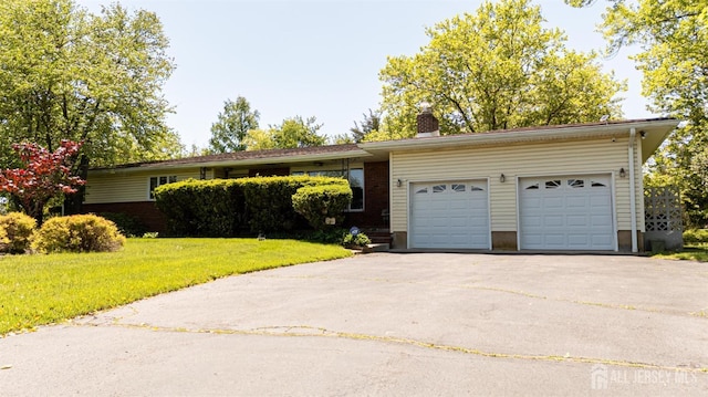 282 Bridgepoint Rd, Montgomery, NJ 08502 - view of front facade with driveway, a front yard, an attached garage, a chimney, and brick siding