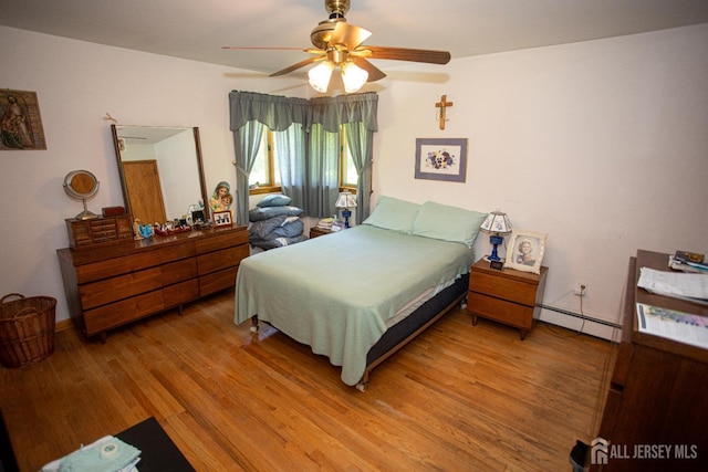 282 Bridgepoint Rd, Montgomery, NJ 08502 - bedroom featuring a baseboard radiator, light wood-style floors, and a ceiling fan