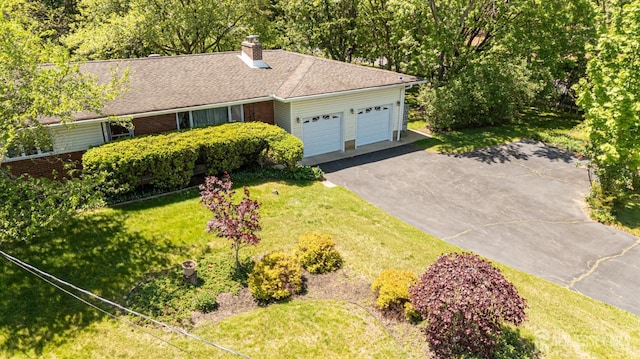 282 Bridgepoint Rd, Montgomery, NJ 08502 - view of front of property featuring a garage, a front yard, driveway, brick siding, and a chimney