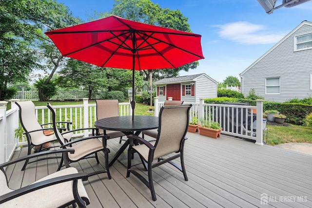 13 Quincy Rd, East Brunswick, NJ 08816 - wooden terrace with outdoor dining space, an outbuilding, and a yard