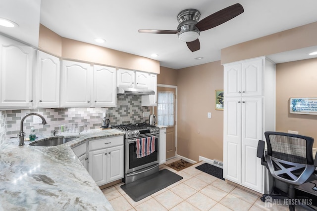13 Quincy Rd, East Brunswick, NJ 08816 - kitchen featuring stainless steel range with gas stovetop, under cabinet range hood, ceiling fan, light stone counters, and decorative backsplash