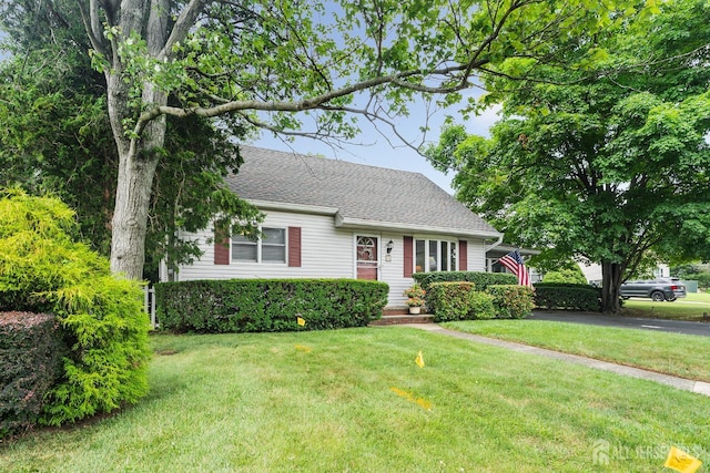 13 Quincy Rd, East Brunswick, NJ 08816 - view of front facade with a front yard and roof with shingles