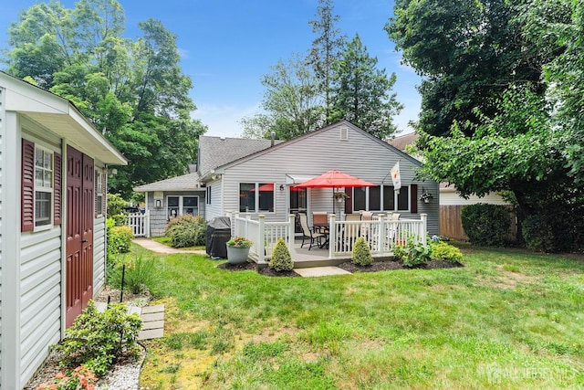 13 Quincy Rd, East Brunswick, NJ 08816 - rear view of house featuring a shingled roof, a deck, and outdoor dining space