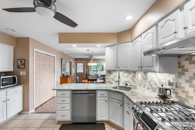13 Quincy Rd, East Brunswick, NJ 08816 - kitchen featuring stainless steel appliances, a ceiling fan, a peninsula, under cabinet range hood, and white cabinets