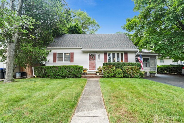 13 Quincy Rd, East Brunswick, NJ 08816 - view of front of property featuring a front yard and a shingled roof