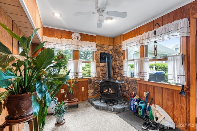 13 Quincy Rd, East Brunswick, NJ 08816 - living room featuring a wood stove, plenty of natural light, wooden walls, a ceiling fan, and carpet