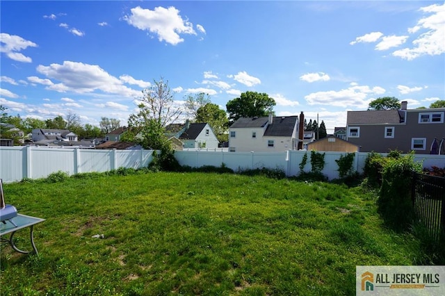 view of yard featuring a residential view and fence