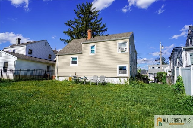 back of property with a chimney