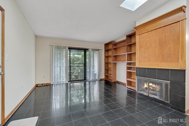 352 Lancaster Ct, Piscataway, NJ 08854 - unfurnished living room featuring a skylight, baseboards, and a tile fireplace