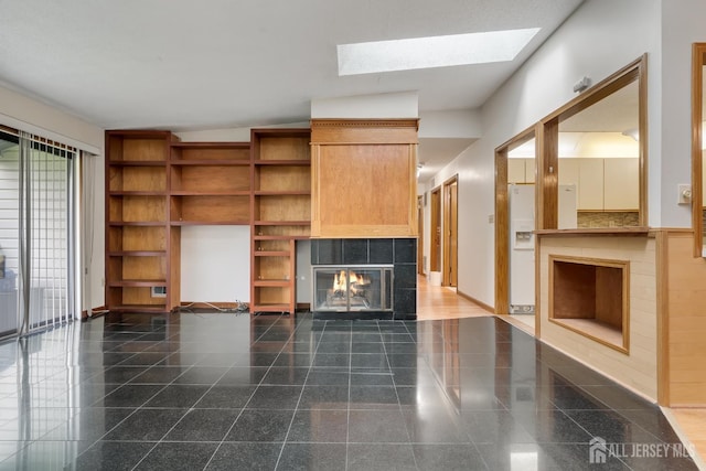 352 Lancaster Ct, Piscataway, NJ 08854 - unfurnished living room featuring a tile fireplace, granite floors, a skylight, and baseboards