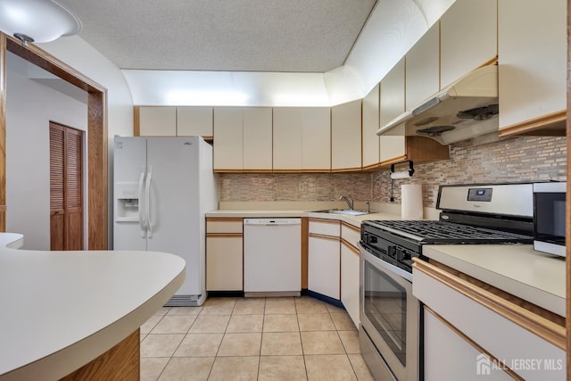 352 Lancaster Ct, Piscataway, NJ 08854 - kitchen featuring white appliances, under cabinet range hood, a sink, light countertops, and backsplash