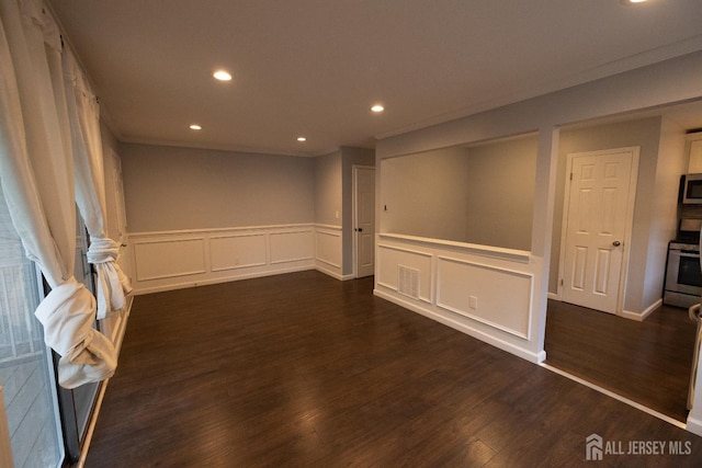 4319 Birchwood Ct, North Brunswick, NJ 08902 - spare room with a decorative wall, wainscoting, recessed lighting, and dark wood-style flooring