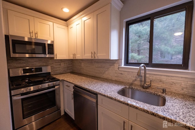 4319 Birchwood Ct, North Brunswick, NJ 08902 - kitchen featuring appliances with stainless steel finishes, white cabinets, light stone counters, tasteful backsplash, and recessed lighting
