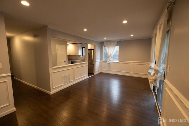 4319 Birchwood Ct, North Brunswick, NJ 08902 - unfurnished living room featuring crown molding, a wainscoted wall, recessed lighting, dark wood-style floors, and a decorative wall