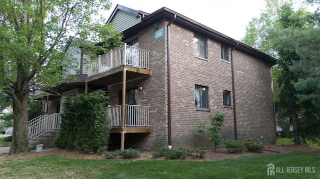 4319 Birchwood Ct, North Brunswick, NJ 08902 - view of home's exterior with a balcony, brick siding, and a yard