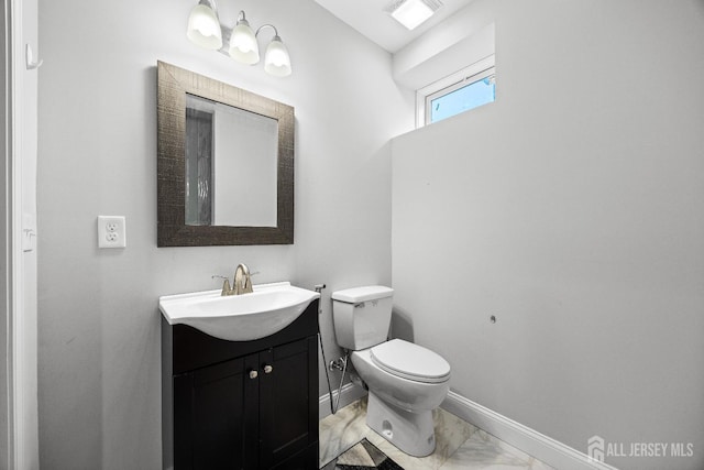 767 Coolidge Ave, Woodbridge Proper, NJ 07095 - bathroom featuring vanity, marble finish floors, toilet, and baseboards