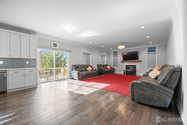 767 Coolidge Ave, Woodbridge Proper, NJ 07095 - living room featuring wood finished floors, a glass covered fireplace, ornamental molding, and recessed lighting