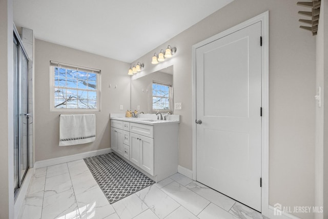 767 Coolidge Ave, Woodbridge Proper, NJ 07095 - bathroom featuring double vanity, marble look tile flooring, plenty of natural light, and baseboards
