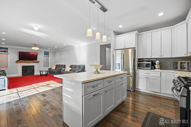 767 Coolidge Ave, Woodbridge Proper, NJ 07095 - kitchen featuring stainless steel appliances, light countertops, dark wood-type flooring, ornamental molding, and white cabinets