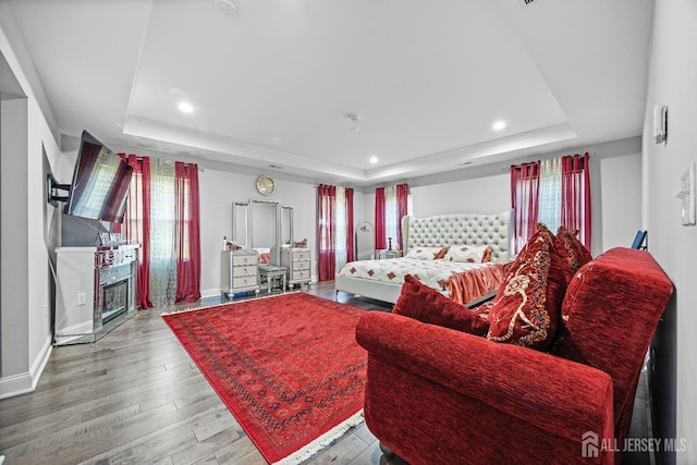 767 Coolidge Ave, Woodbridge Proper, NJ 07095 - living room with a tray ceiling, wood finished floors, recessed lighting, baseboards, and a glass covered fireplace