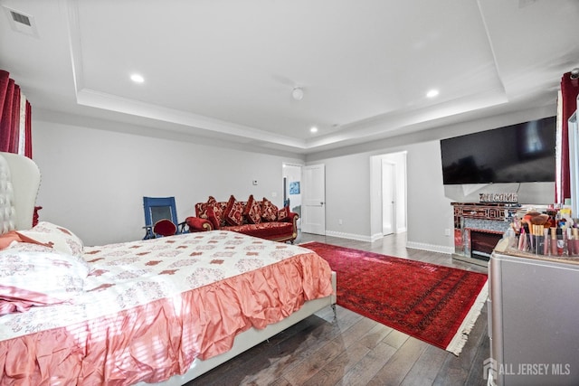 767 Coolidge Ave, Woodbridge Proper, NJ 07095 - bedroom featuring a tray ceiling, wood finished floors, recessed lighting, baseboards, and a fireplace