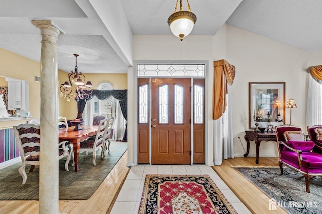 47 Birmingham Ln, Monroe, NJ 08831 - foyer entrance with a chandelier, decorative columns, and light wood-style flooring