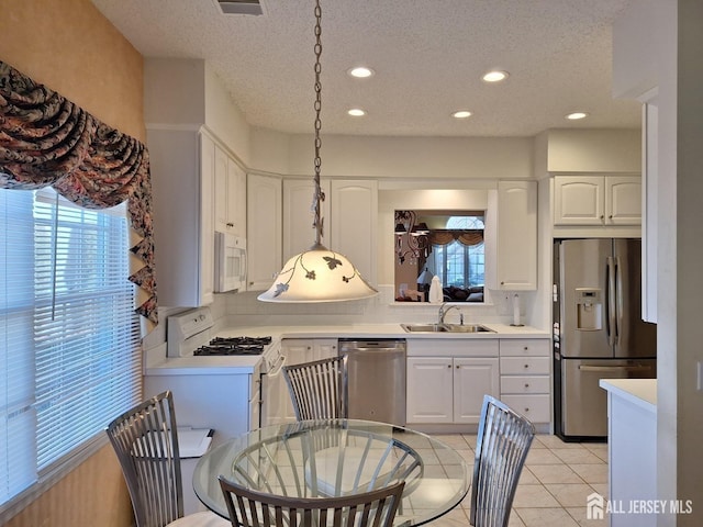 47 Birmingham Ln, Monroe, NJ 08831 - kitchen featuring appliances with stainless steel finishes, healthy amount of natural light, a textured ceiling, backsplash, and light countertops