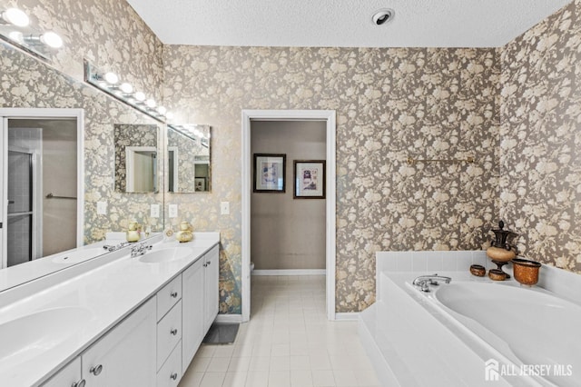 47 Birmingham Ln, Monroe, NJ 08831 - bathroom with double vanity, a bath, tile patterned floors, a textured ceiling, and wallpapered walls