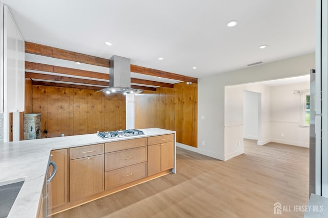 4 Hickory Trl, Flemington, NJ 08822 - kitchen with beam ceiling, light wood-style flooring, light brown cabinetry, wooden walls, and island range hood
