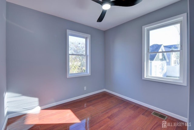 spare room with ceiling fan and wood-type flooring